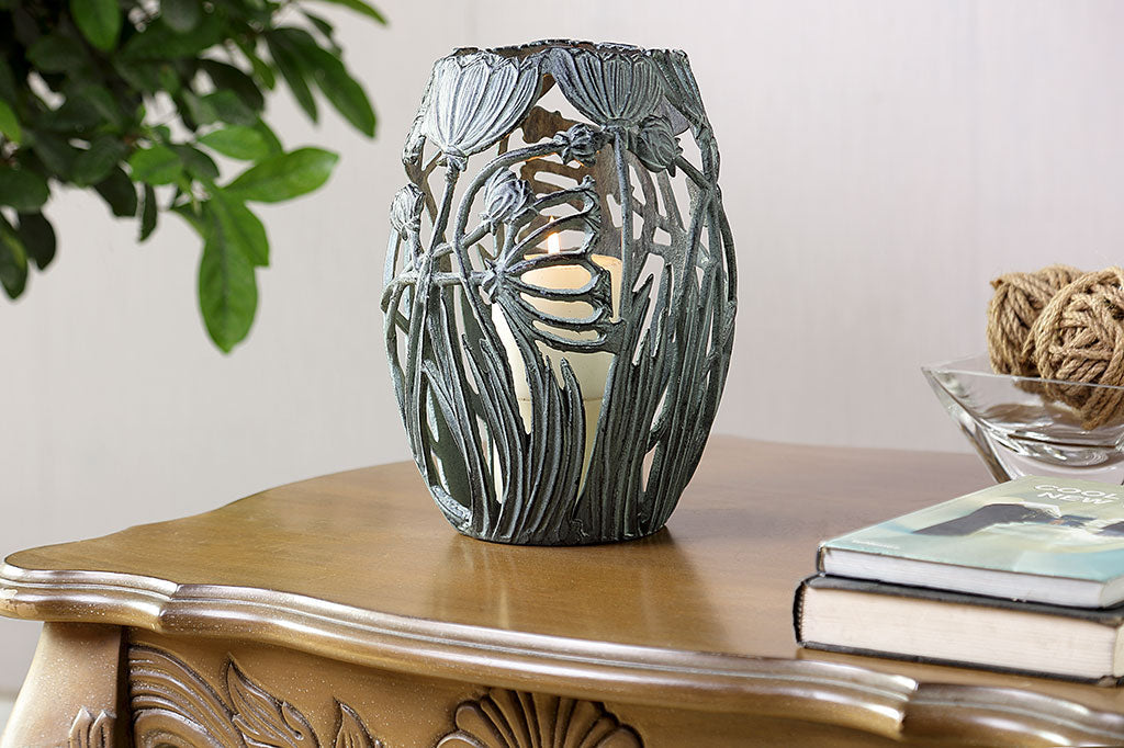 A Garden Party Candleholder shown on dresser in home interior with a lit candle