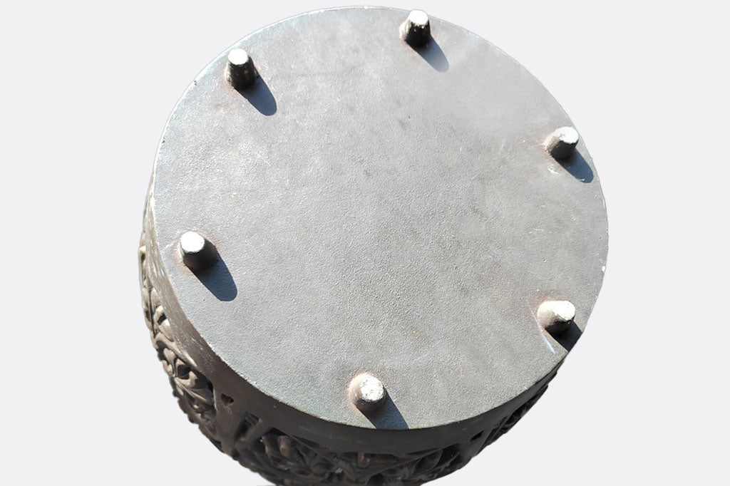 View of base of stool showing a solid base with six peg feet