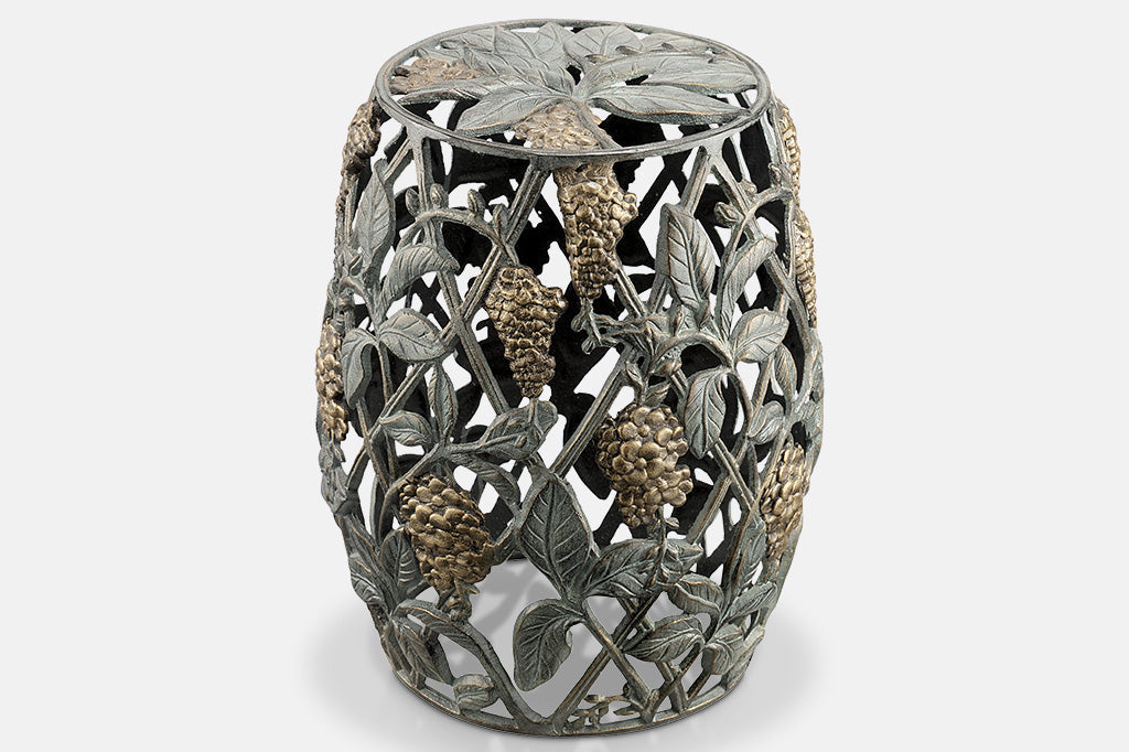 Cast metal garden stool of lattice design and vining blossoms