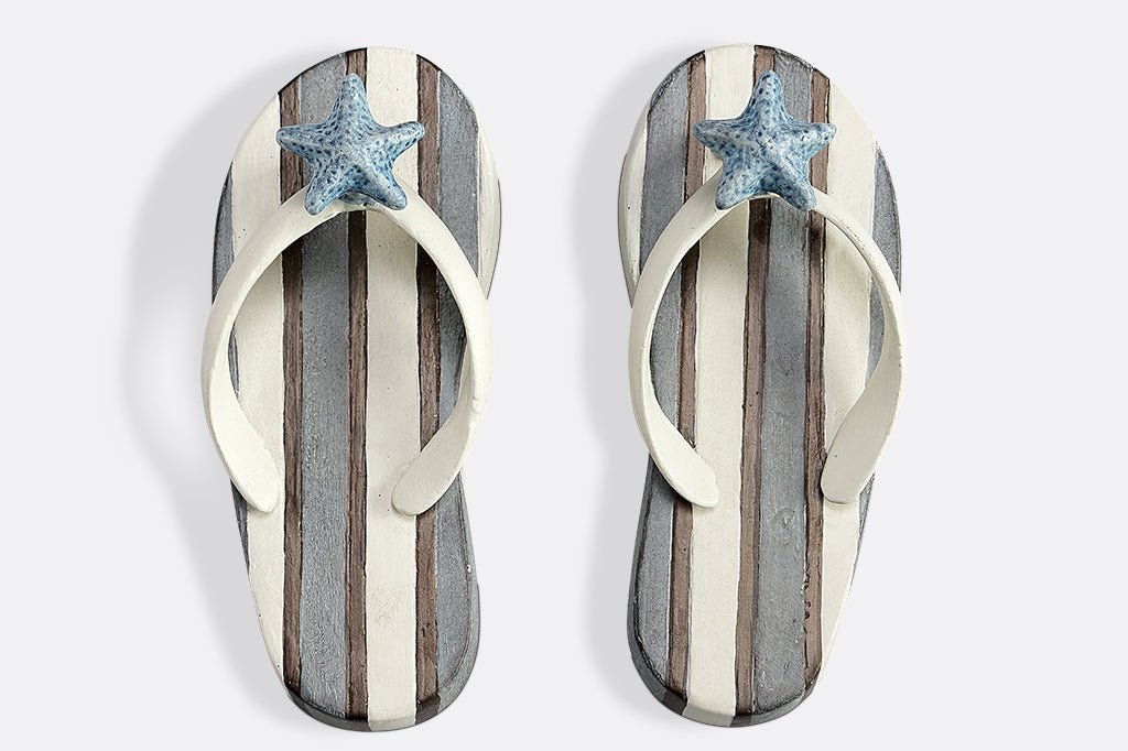 Wall hooks shaped like pair of blue and white striped flip flops with sea shell motif #color_stripe