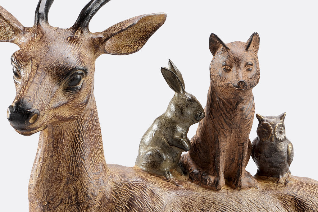 Cast metal critters on back of deer, bunny, fox, and owl