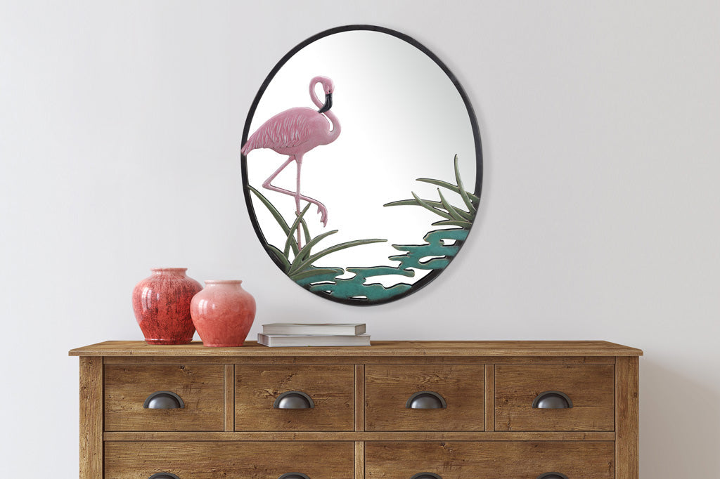 cast metal pink flamingo mirror, water and cattail. on wall over cabinet