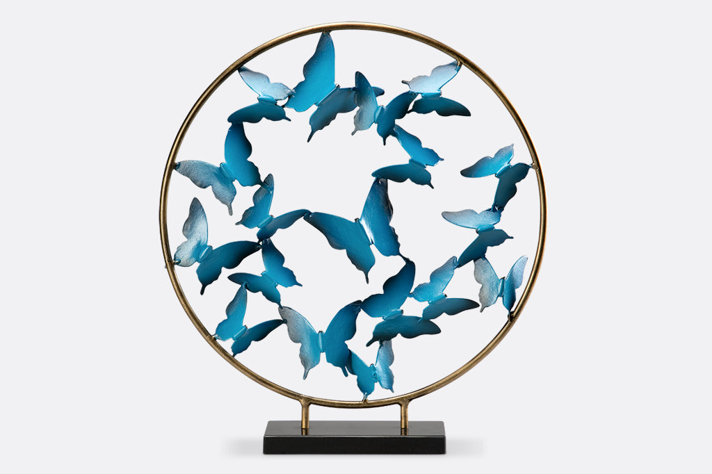 Blue Butterfly burst with marble base shows sculpture of hoop filled with flying blue sculpted butterflies