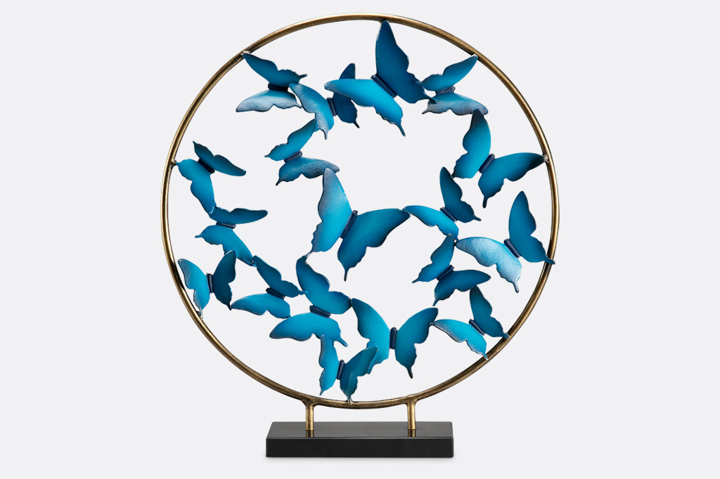Blue Butterfly burst with marble base shows sculpture of hoop filled with flying blue sculpted butterflies