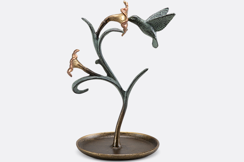 jewelry holder shaped like growing lily with humming bird visiting it.