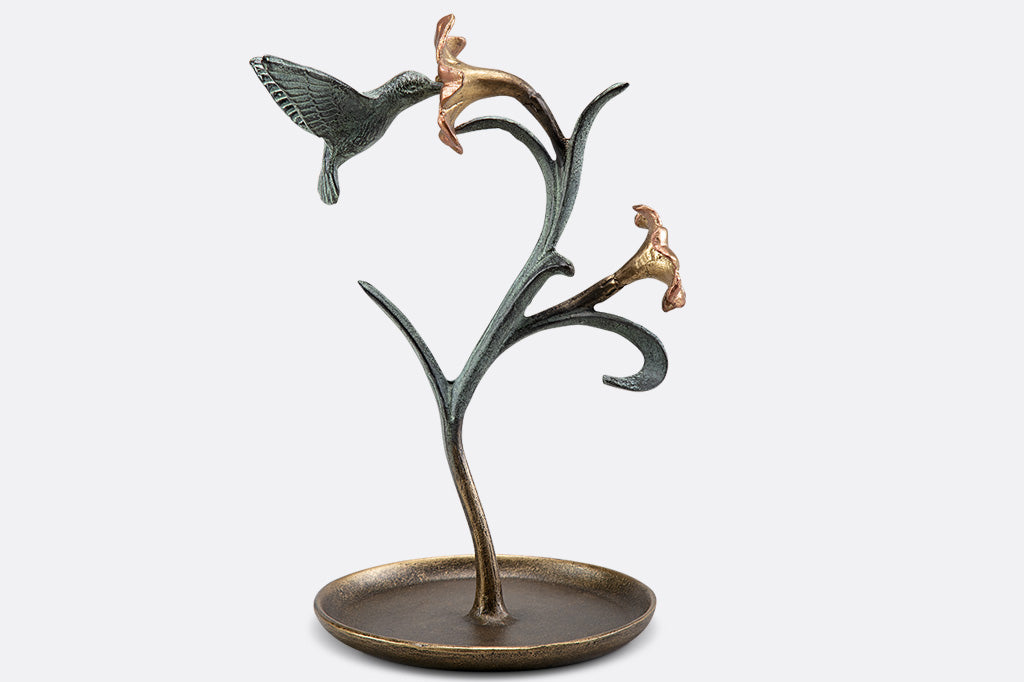 jewelry holder shaped like growing lily with humming bird visiting it.