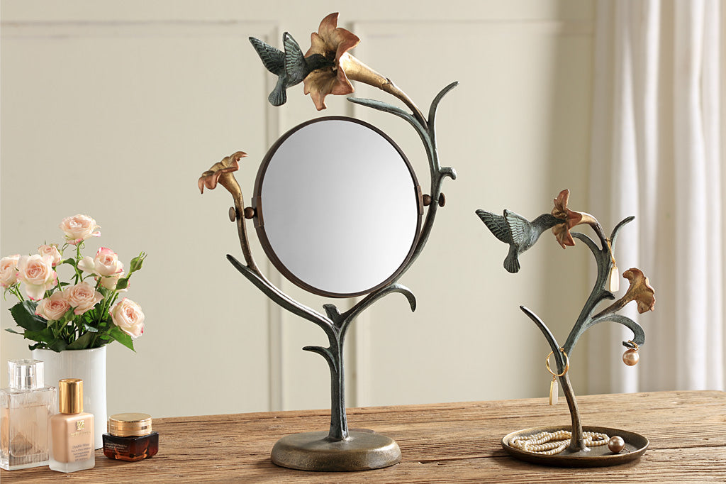 jewelry holder shaped like growing lily with humming bird visiting it. shown with matching vanity mirror