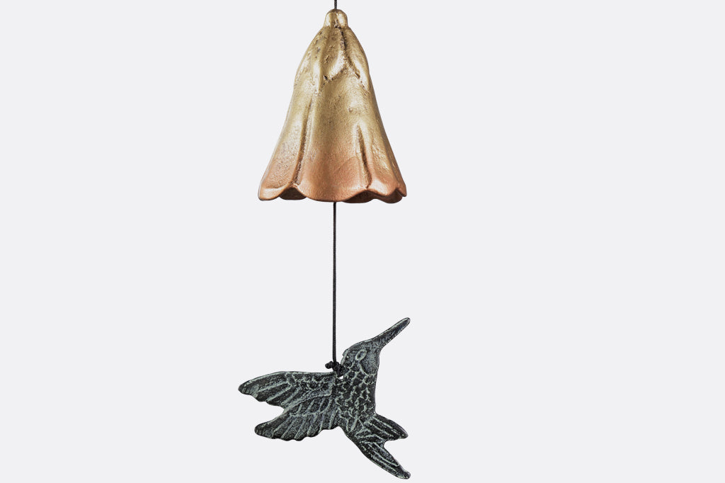 sculpted metal wind art with motif of encircled lily and hummingbird with 3 lily blossoms suspended below with a hummingbird pendant