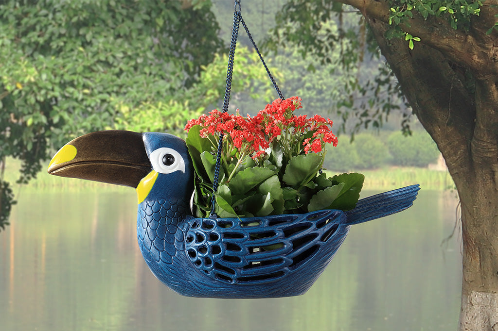 hanging toucan planter in front of lake