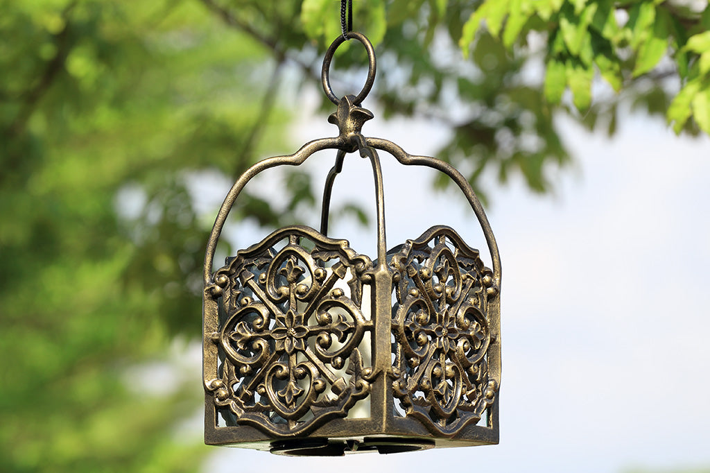 italianate fretwork hanging lantern box with 1 pillar candle shown hanging from tree