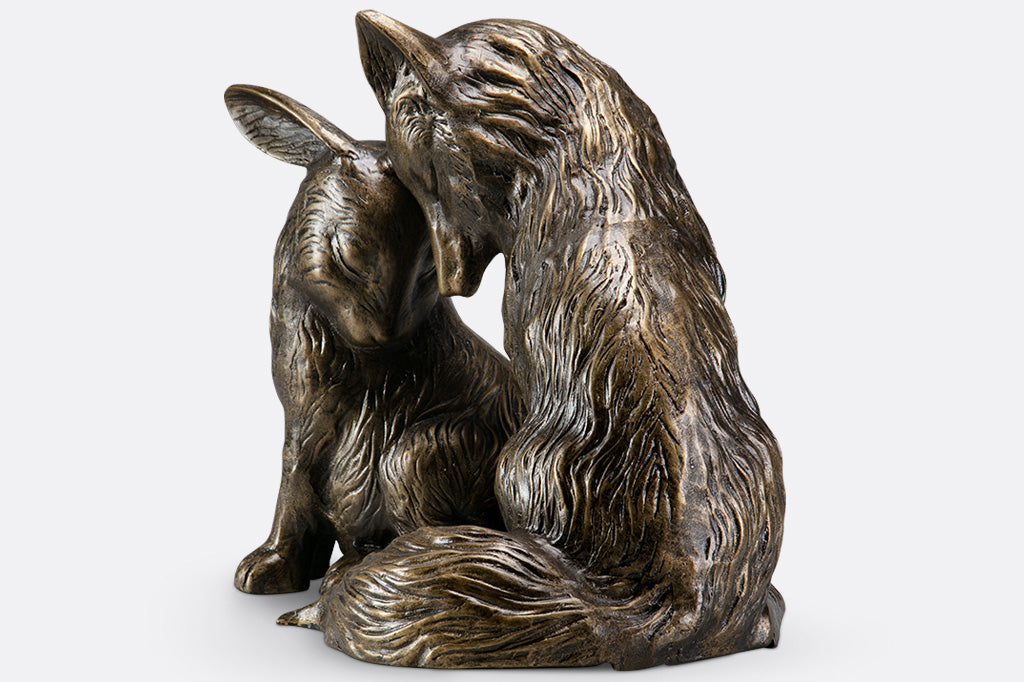 other side view of Garden sculpture of fox and rabbit tenderly nuzzling
