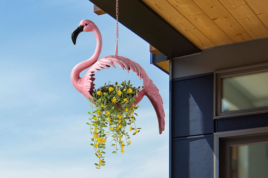 hanging planter shown hanging from roof with yellow vines coming from a flamingo shaped boday