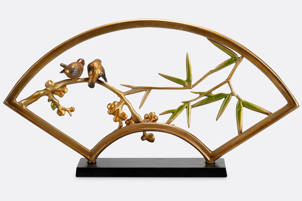 "tranquility sculpture" is a fan shaped table sculpture with bamboo, blossom, and bird features with shimmering features