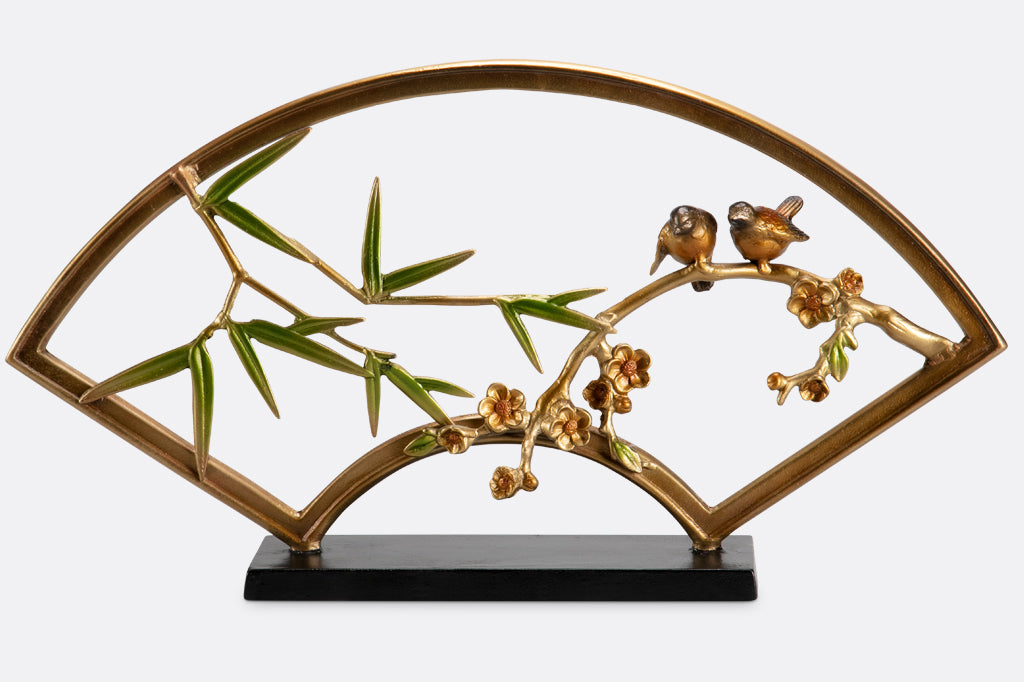 "tranquility sculpture" is a fan shaped table sculpture with bamboo, blossom, and bird features with shimmering features