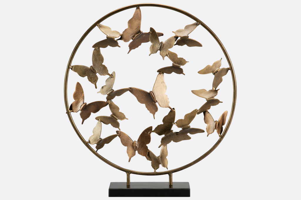 Brass Butterfly burst with marble base shows sculpture of hoop filled with butterflies