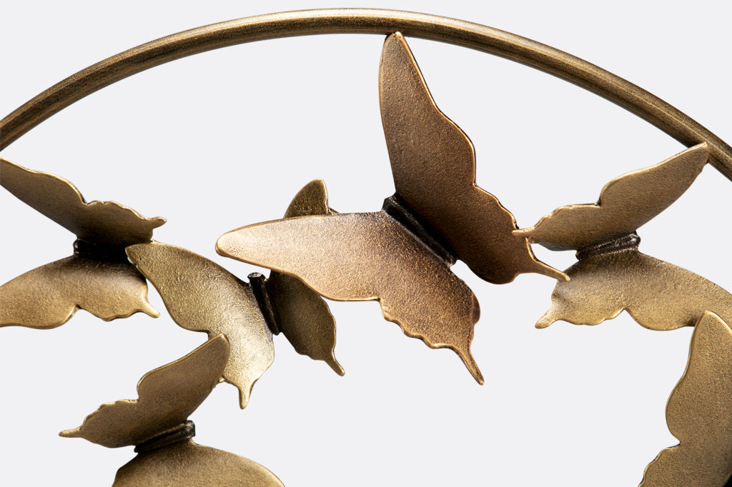Closeup of brass finish on metal butterflies