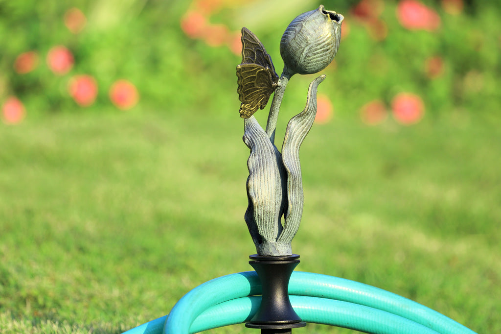 on lawn by hose, tulip shaped hose guard with golden butterfly