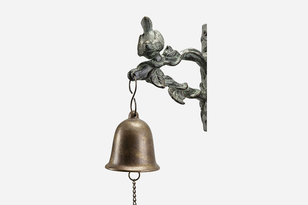 Closeup view of bird, branch, and bell on the Songbird Mounted Wind Bell