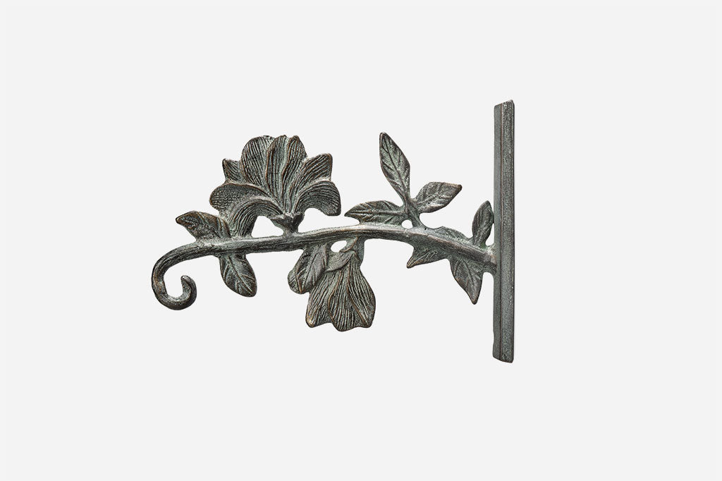 The Magnolia Dawn Mounted Hanger close up of hand-sculpted cast metal magnolia and vine detailing