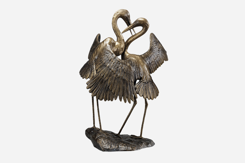 Two cranes embracing sculpture