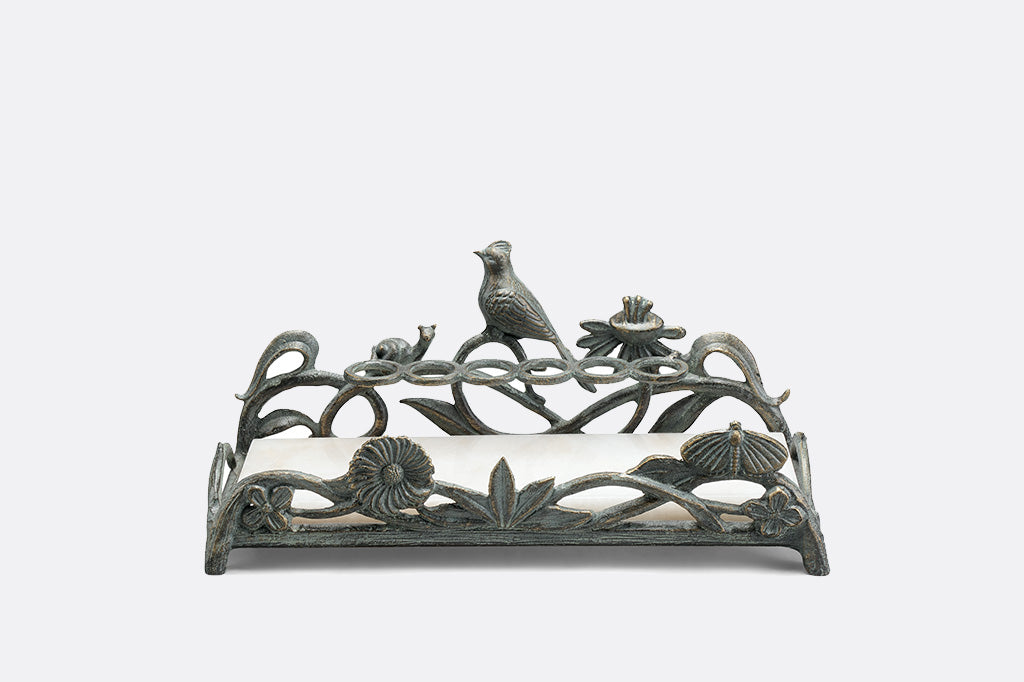 metal vanity tray with floral, bird and snail detailing. Special rings to hold lipsticks and a white marble base.