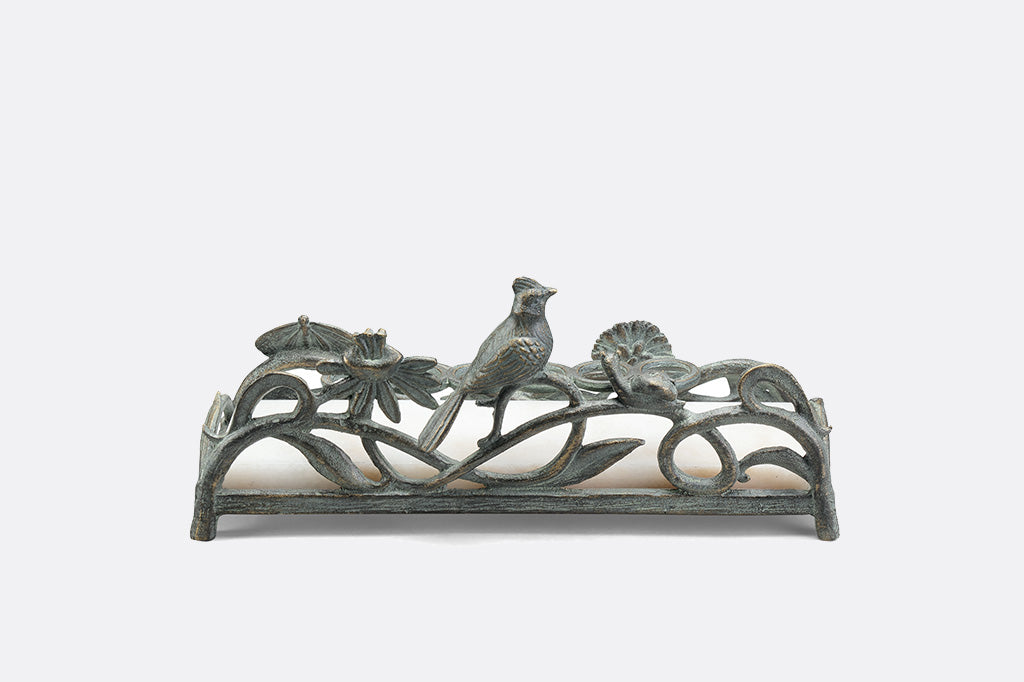 metal vanity tray with floral, bird and snail detailing. Special rings to hold lipsticks and a white marble base.