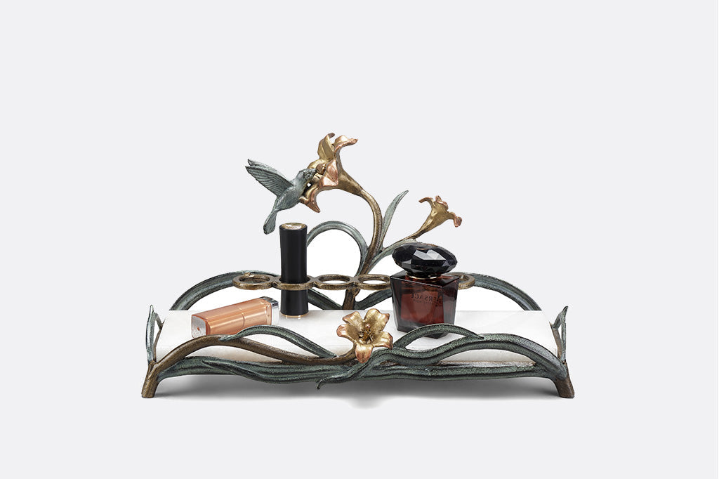 humming bird vanity tray featuring lipstick rings and a with white marble base with perfume and lipsticks
