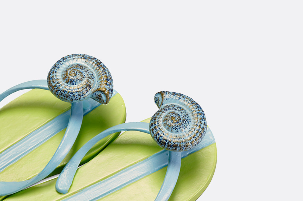 Pair of flip flop hooks feature a whorl shell in blue, gold, and speckles #color_aquamarine