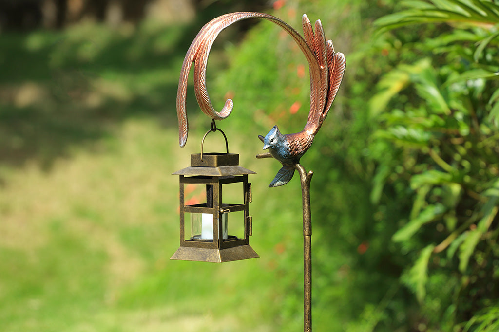 Flycatcher outdoor staked lantern with votive candle staged in garden background