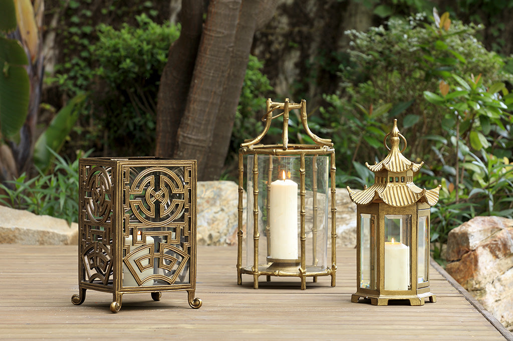collection of three Asian inspired lanterns in gold and bronze finishes