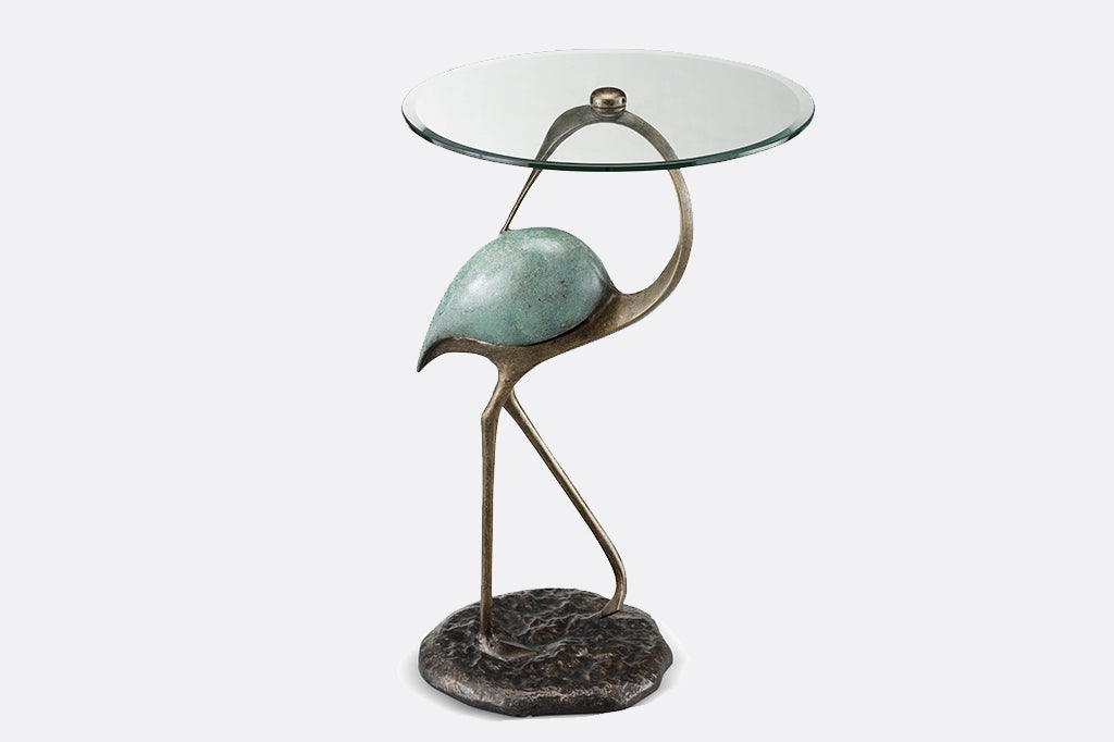 Elegant crane sculpture is the base for a drink table with glass top