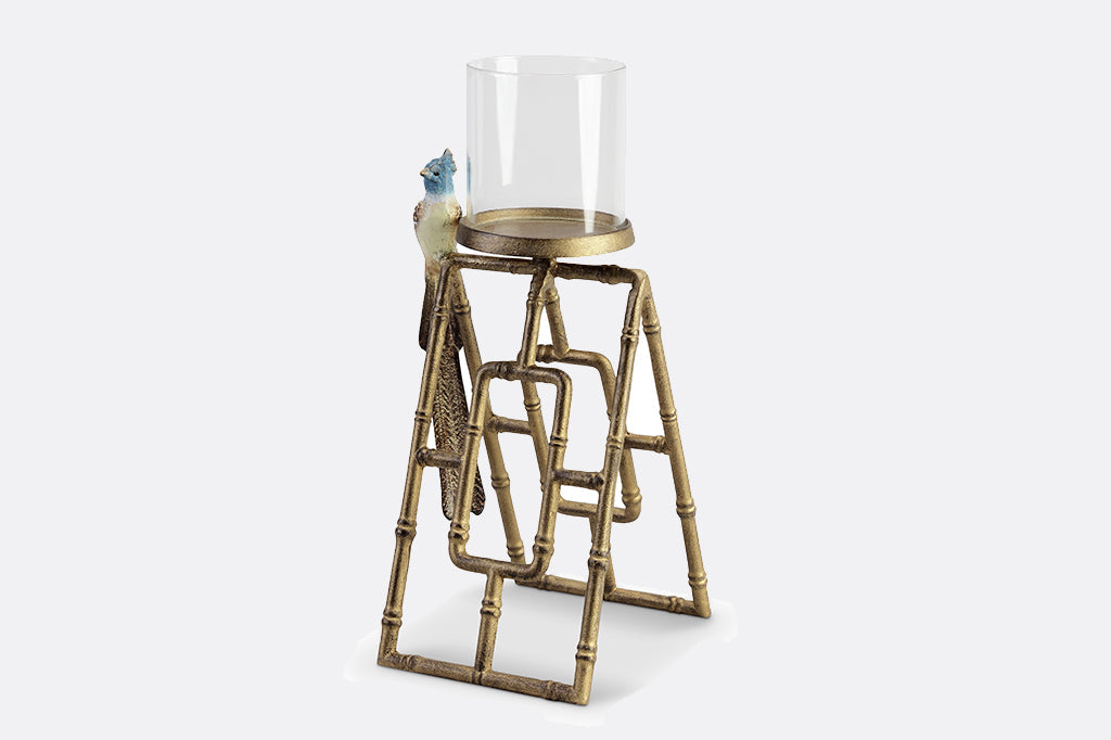 cast metal candleholder, gold color with bamboo detailing with blue flycatcher on side. Glass hurricane candle holder