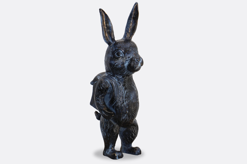Black metal bunny sculpture with blue and bronze highlights