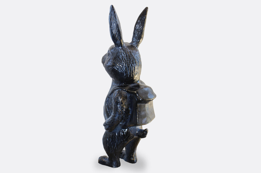 Black metal bunny sculpture with blue and bronze highlights