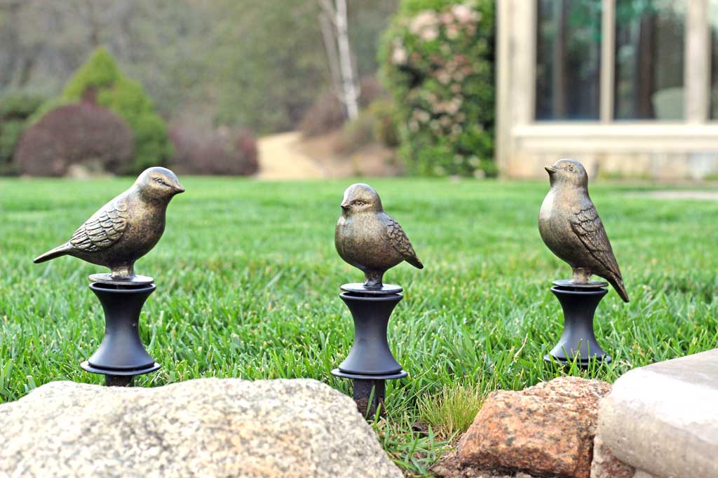 Bird Hose Guard Set shows bronze birds in 3 poses; designed to keep hoses from crushing plants on the ground
