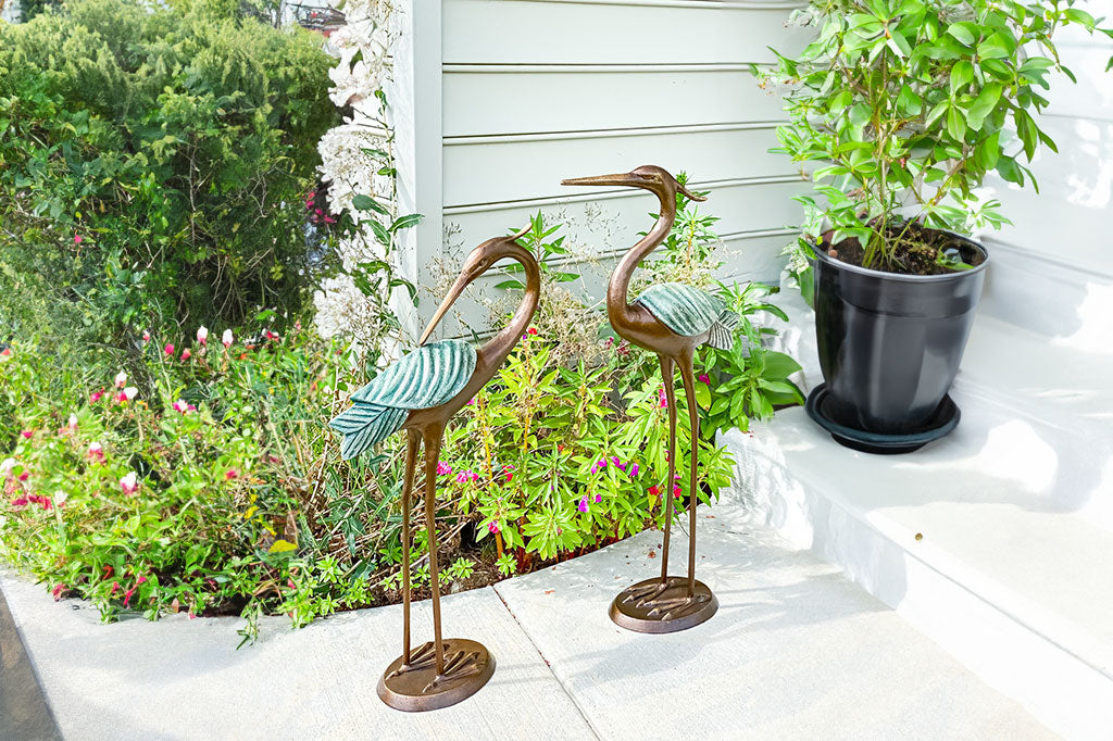 Set of two cast metal heron garden sculptures set bedside garden bed