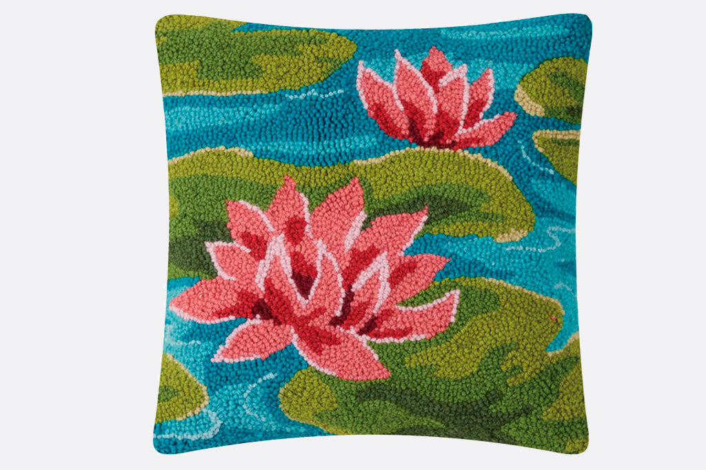 Hooked wool water lilies and lily pads on water pillow, pink blossoms, green lily pads on blue water