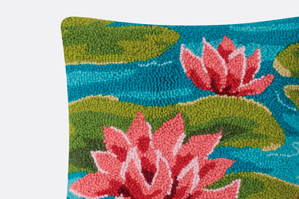 Hooked wool water lilies and lily pads on water pillow, pink blossoms, green lily pads on blue water