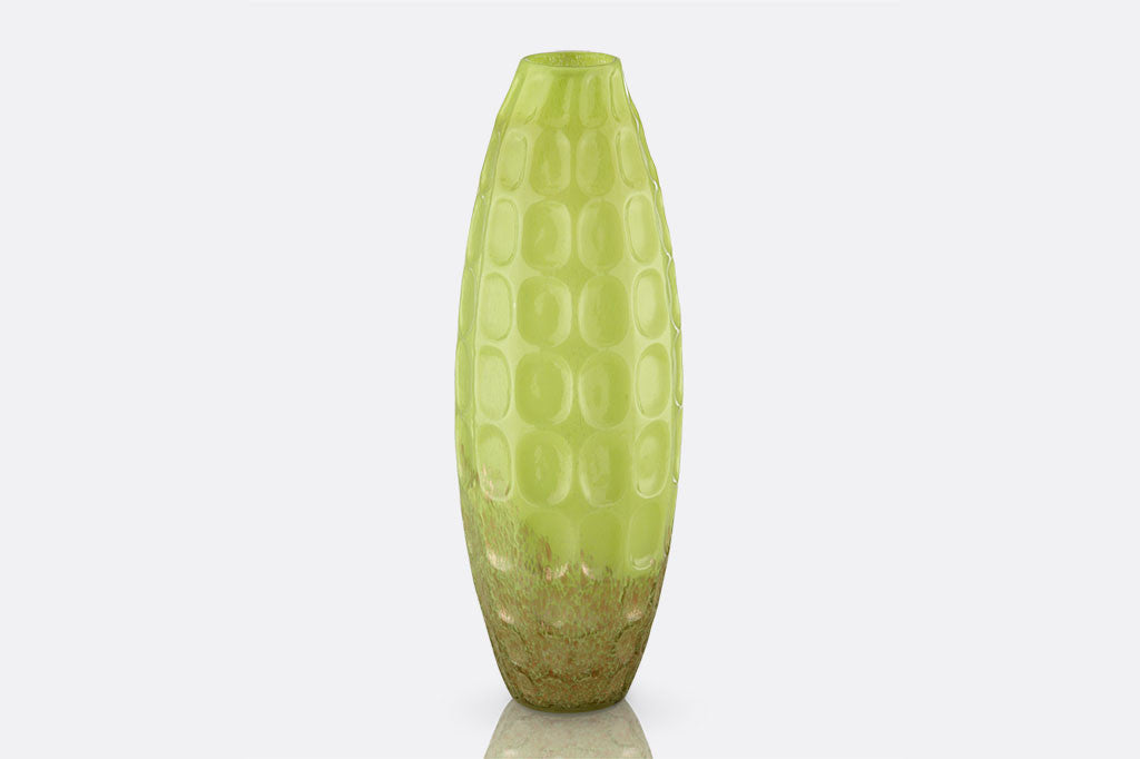 glass vase with vivid yellow-green colors and geometric indentations