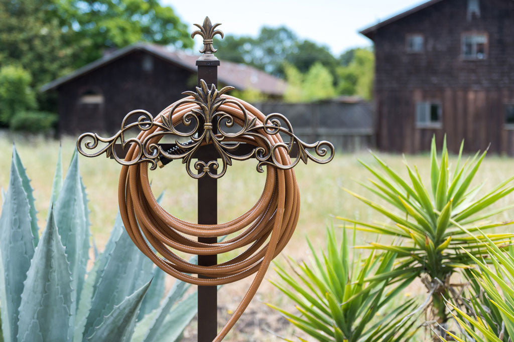 Alloro Hose Holder (Stake) shown near cacti in farmhouse setting