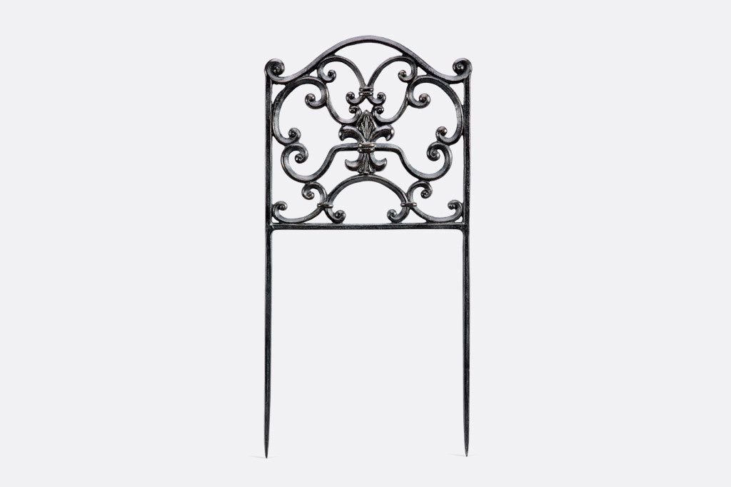 Rouleau Garden Edging shows scrollwork in zinc colors in frame designed to border paths