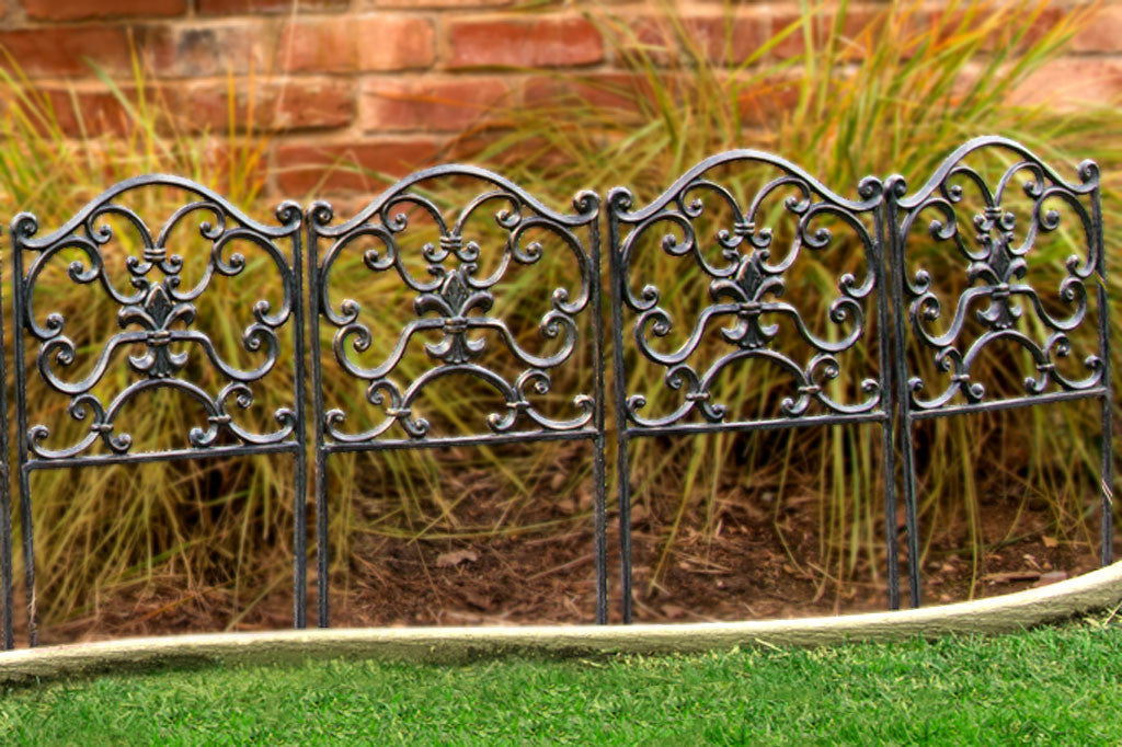 Rouleau Garden Edging shows scrollwork in zinc colors in frame designed to border paths - shown by houseplants and bordering a lawn