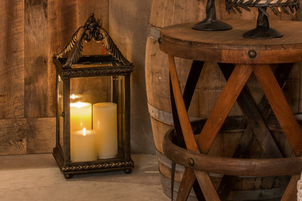 Foglia Lantern shown on winery floor near wood casks and table furniture