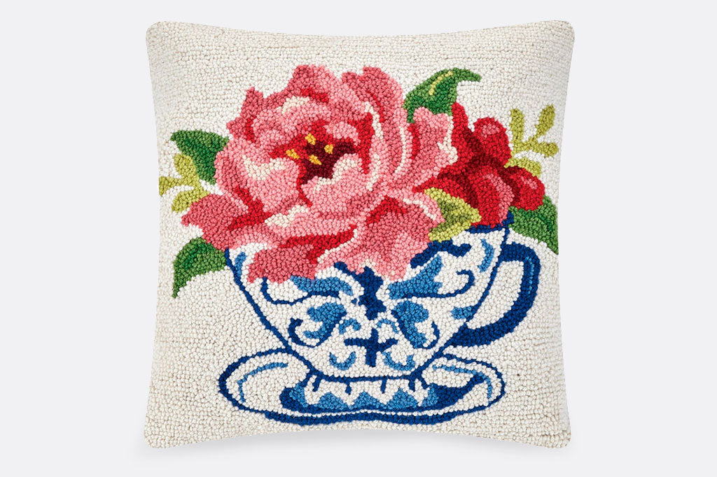 Hooked wool pillow, blue chinoiserie teacup with pink peony and foliage atop teacup