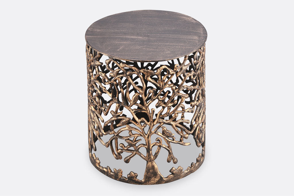 Cast metal stool with tree and bird detailing, flat top copper with black highlights