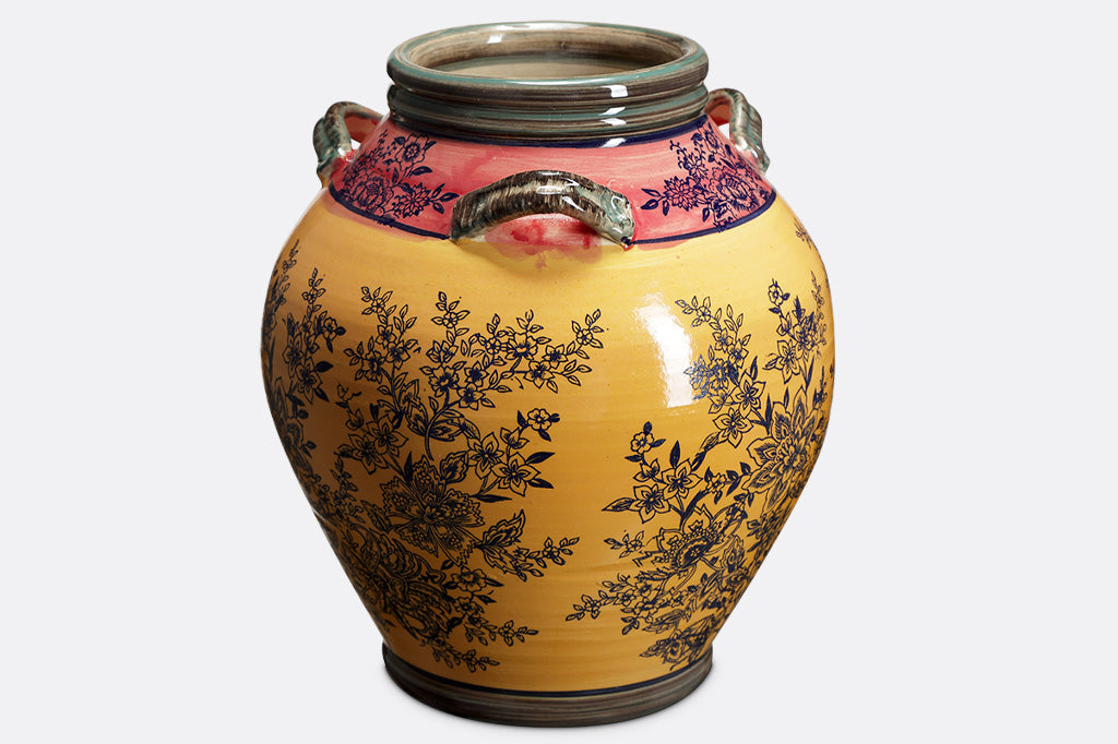view of Melone e Oro showing 3 handles on a ceramic base printed in dark color with a spray of flowers