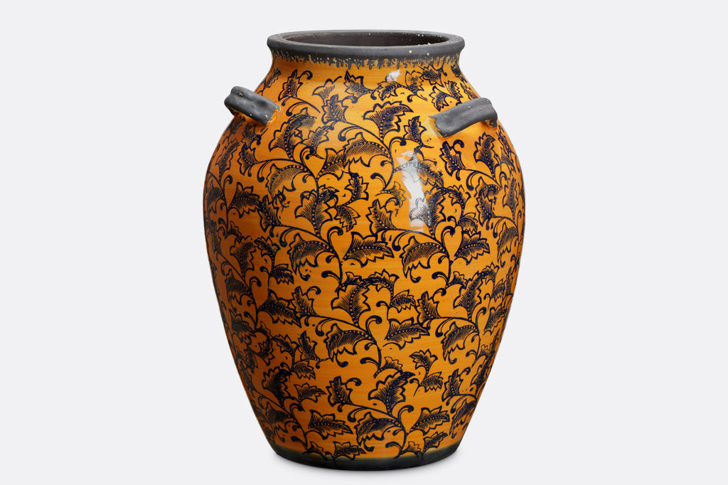 leaf and vine printed tall ceramic jar; gray handles and rim; deep orange-yellow glaze