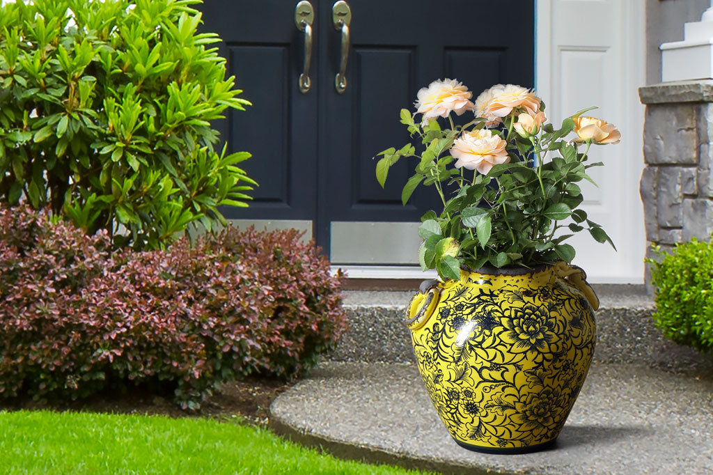 Pera Pot holding roses on a walkway near house