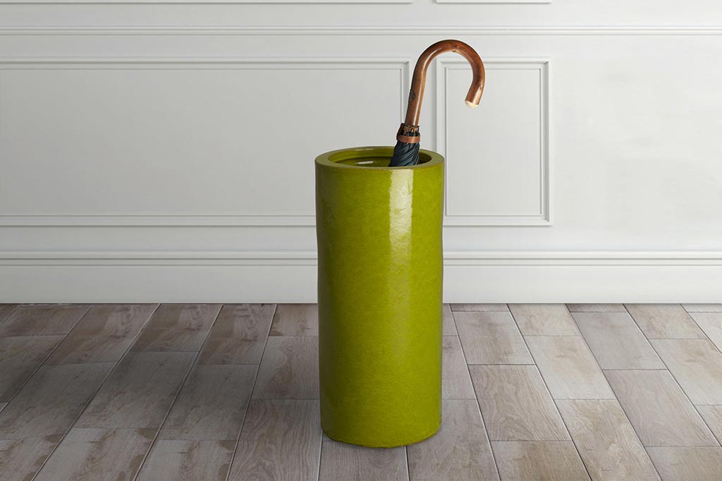 green umbrella stand with umbrella inside