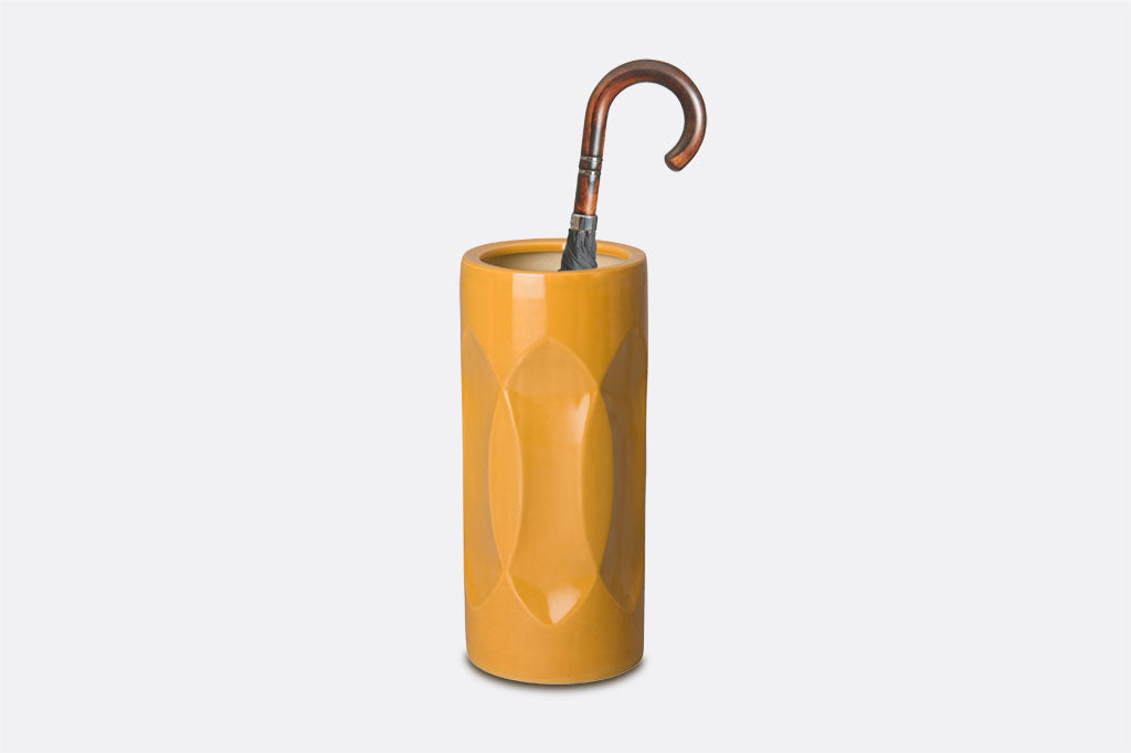 yellow ceramic umbrella stand shown with umbrella